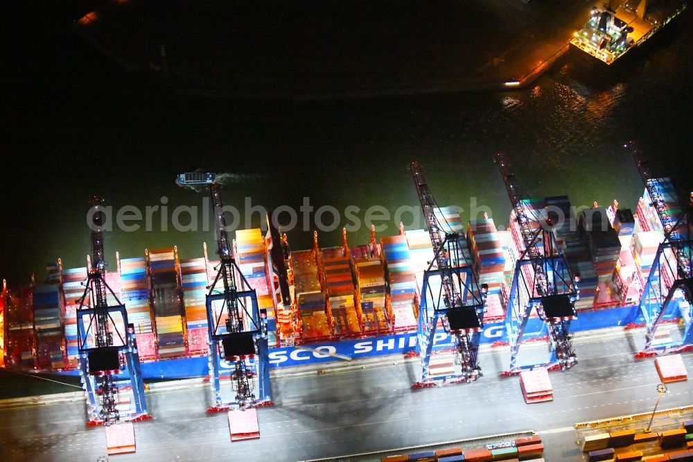 Aerial photograph at night Hamburg - Night lighting container ship on den HHLA Container Terminal Tollerort Am Vulkonhafen in the port in the district Steinwerder in Hamburg, Germany