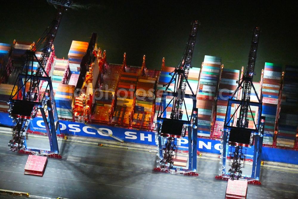 Aerial image at night Hamburg - Night lighting container ship on den HHLA Container Terminal Tollerort Am Vulkonhafen in the port in the district Steinwerder in Hamburg, Germany