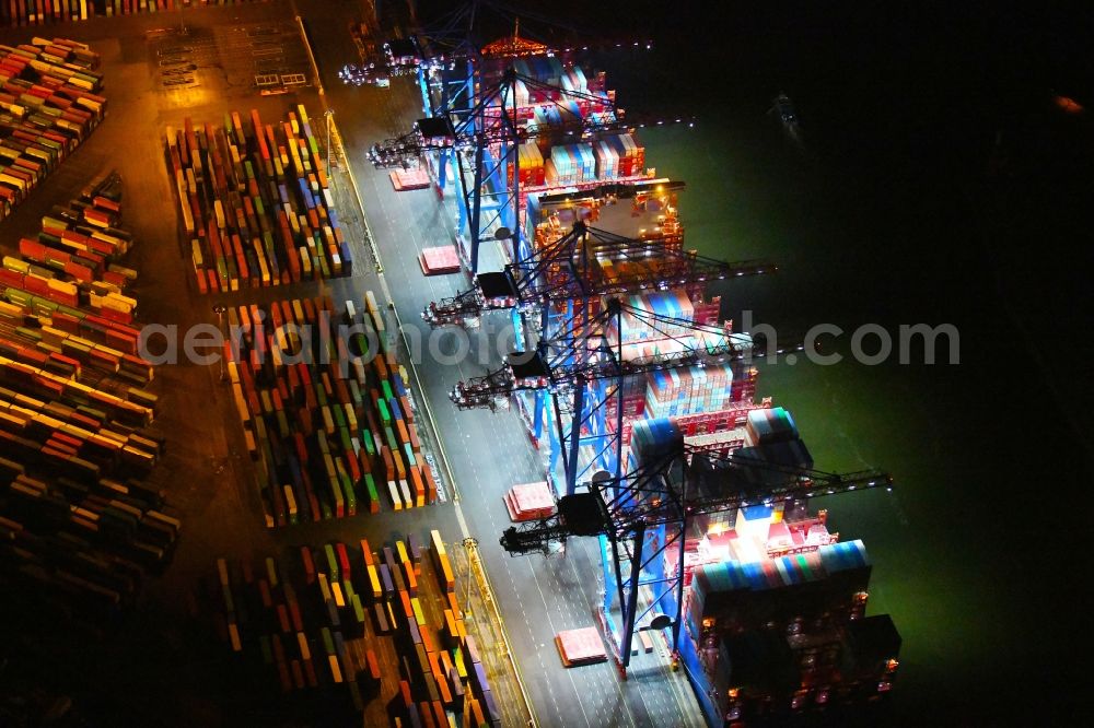 Aerial photograph at night Hamburg - Night lighting container ship on den HHLA Container Terminal Tollerort Am Vulkonhafen in the port in the district Steinwerder in Hamburg, Germany