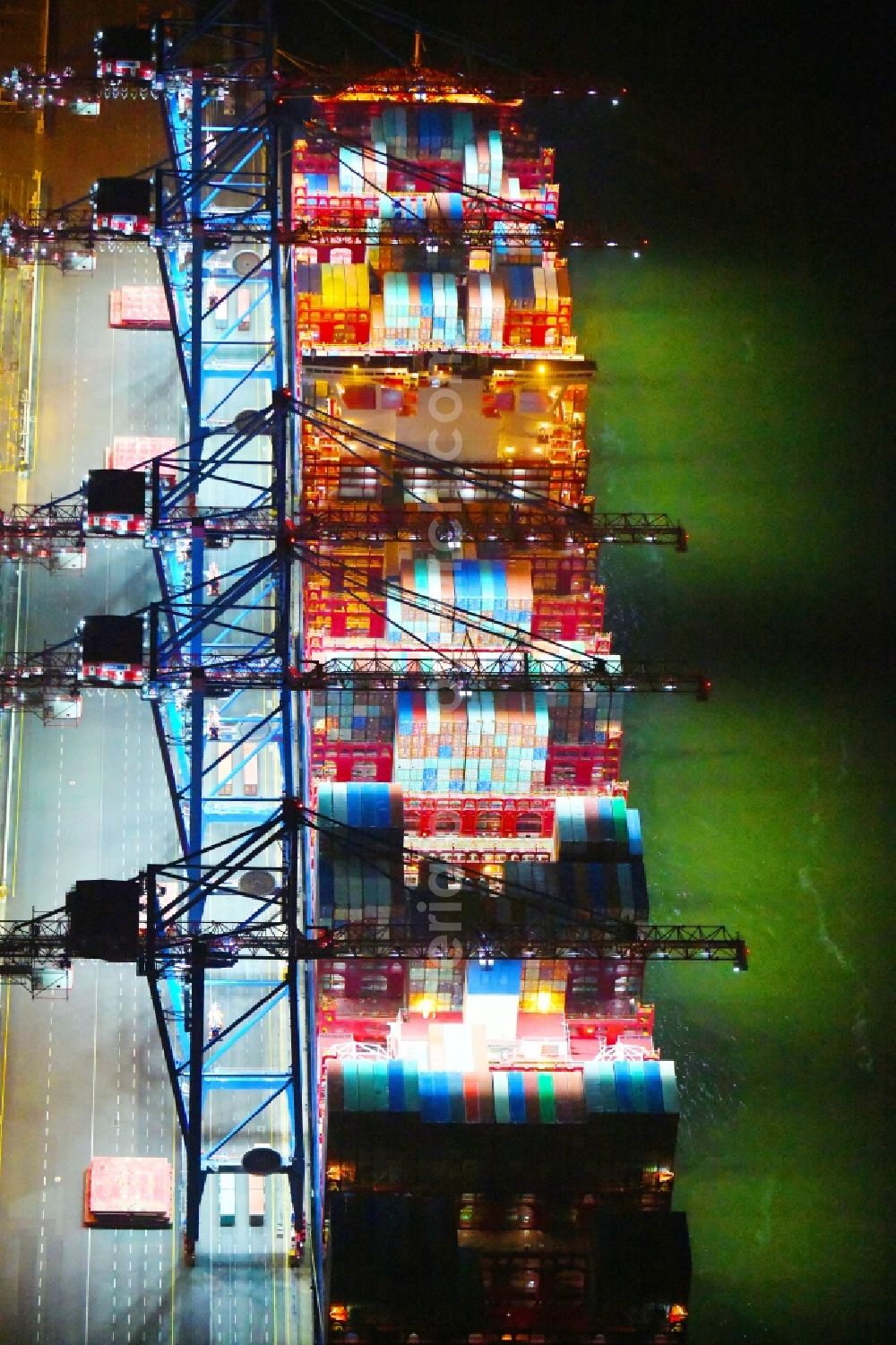 Hamburg at night from above - Night lighting container ship on den HHLA Container Terminal Tollerort Am Vulkonhafen in the port in the district Steinwerder in Hamburg, Germany