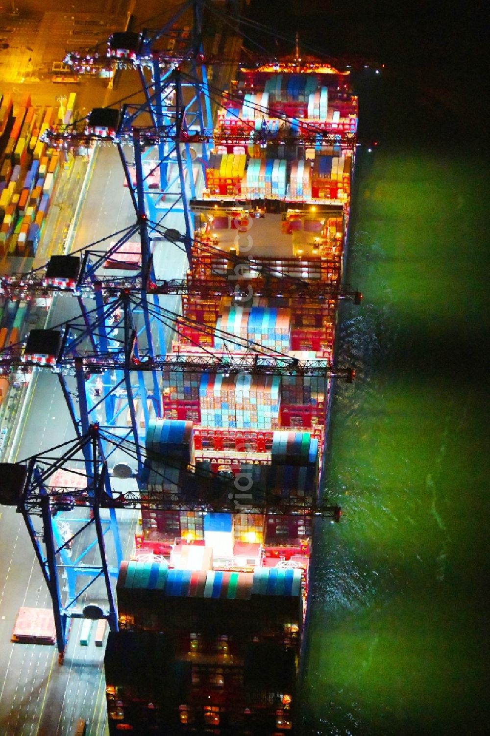 Aerial image at night Hamburg - Night lighting container ship on den HHLA Container Terminal Tollerort Am Vulkonhafen in the port in the district Steinwerder in Hamburg, Germany