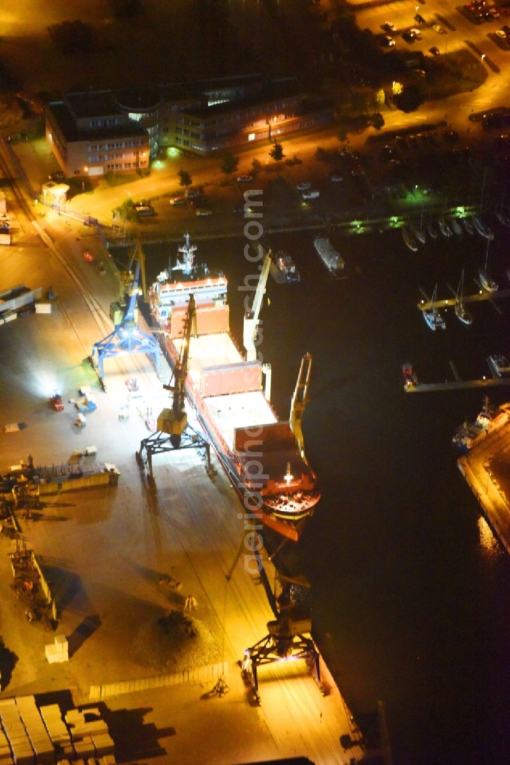 Aerial photograph at night Wismar - Night lighting Container ship Am Westhafen in the port in Wismar in the state Mecklenburg - Western Pomerania, Germany