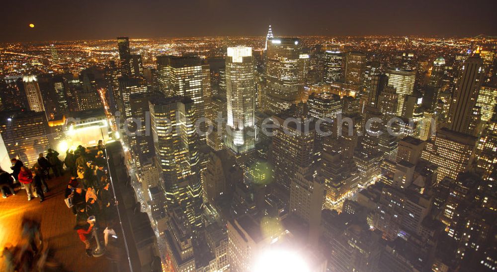 Aerial image at night New York - Night Aerial photo of the Midtown Center in Manhattan in New York. Midtown Manhattan is an important financial district in New York City and is considered as the largest commercial center of the United States