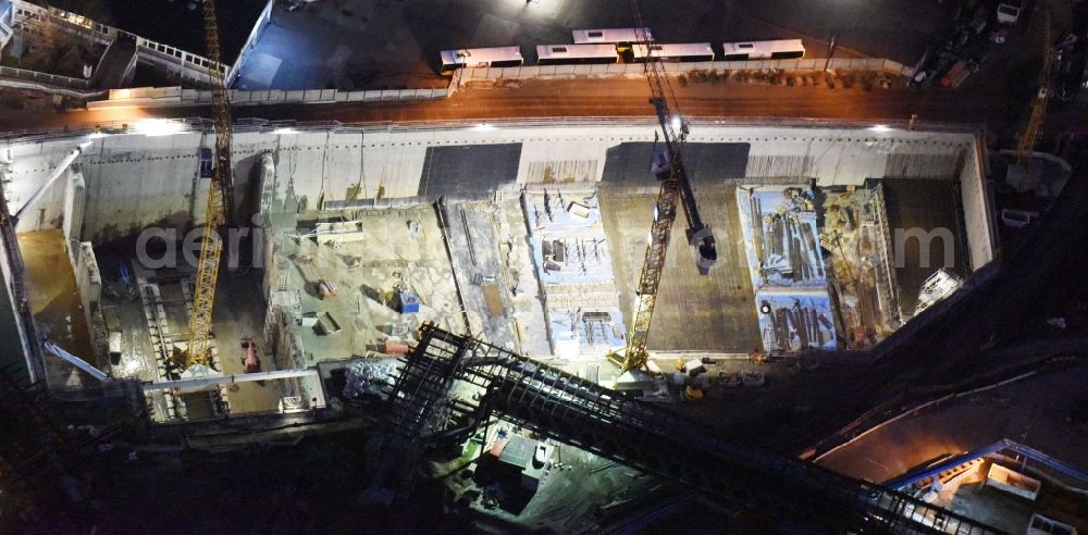 Aerial image at night Berlin - Night image of the civil engineering construction sites for construction of the extension of the urban motorway - Autobahn Autobahn A100 in Berlin Neukoelln