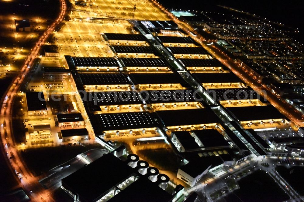 München at night from the bird perspective: Night view of the Fairgrounds Munich in the state Bavaria