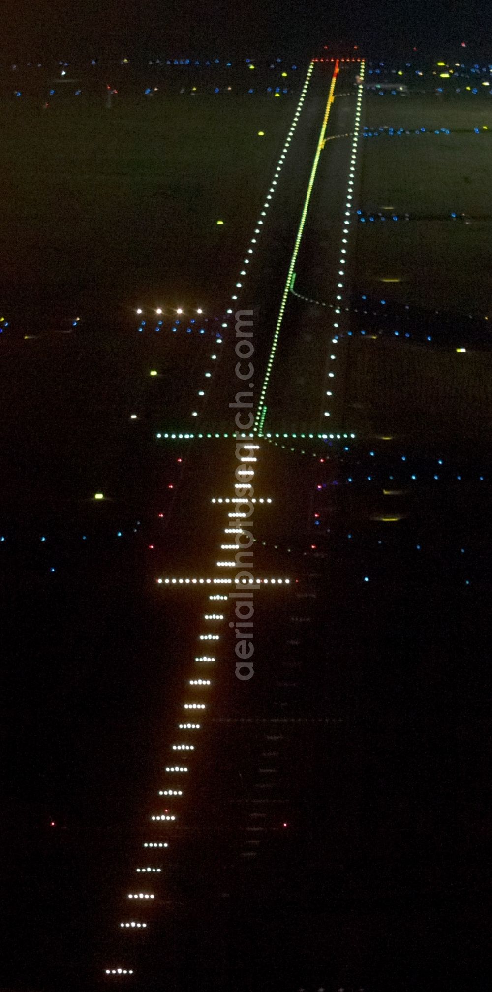 Düsseldorf at night from above - Night aerial view of the illuminated runway 07 right at the Dusseldorf airport in North Rhine-Westphalia