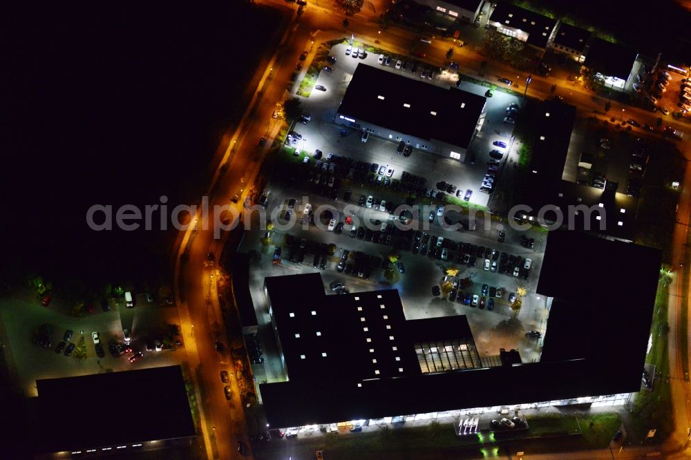 Berlin Biesdorf at night from the bird perspective: Night aerial photo of a BMW branch Marzahn in the district Biesdorf in Berlin