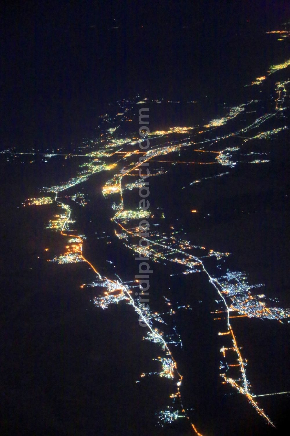 Aerial image at night Nagaa El-Shaikh - Night lighting along the river course of the Nile at Nagaa El-Shaikh in Aswan Governorate, Egypt