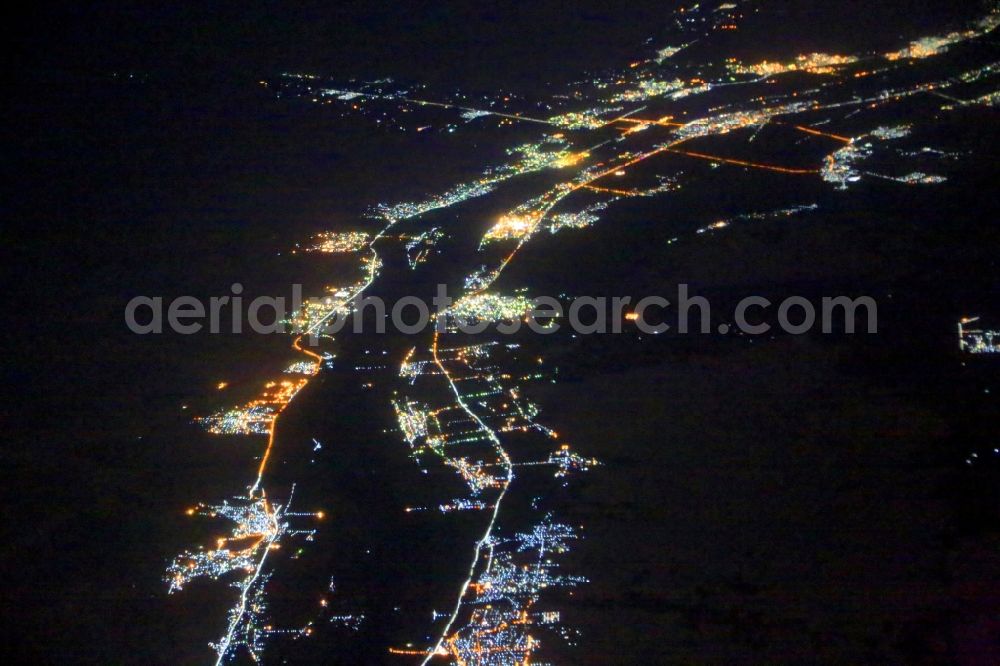 Nagaa El-Shaikh at night from above - Night lighting along the river course of the Nile at Nagaa El-Shaikh in Aswan Governorate, Egypt