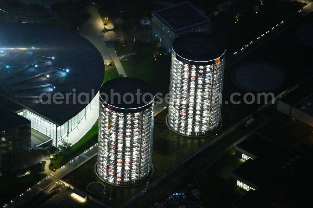 Wolfsburg at night from above - Night lighting Tourist attraction and sightseeing Autostadt GmbH on factorysgelaende of Volkswagen AG in Wolfsburg in the state Lower Saxony, Germany