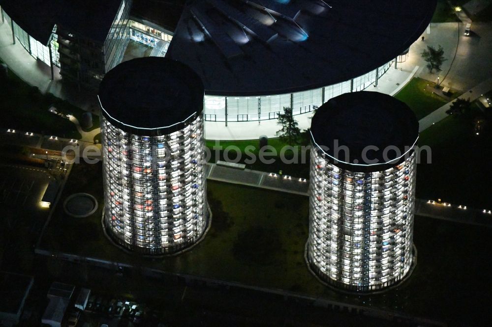 Wolfsburg at night from above - Night lighting Tourist attraction and sightseeing Autostadt GmbH on factorysgelaende of Volkswagen AG in Wolfsburg in the state Lower Saxony, Germany