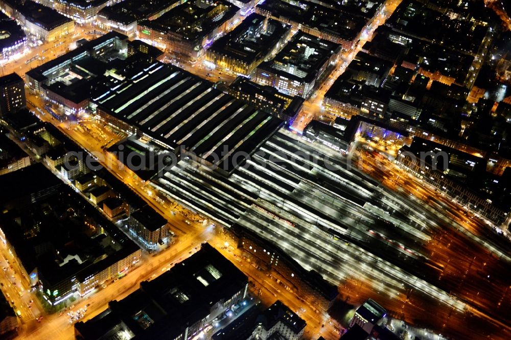 Aerial image at night München - Night aerial view of the tracks and rails at the train station building of the main station of Munich in Bavaria