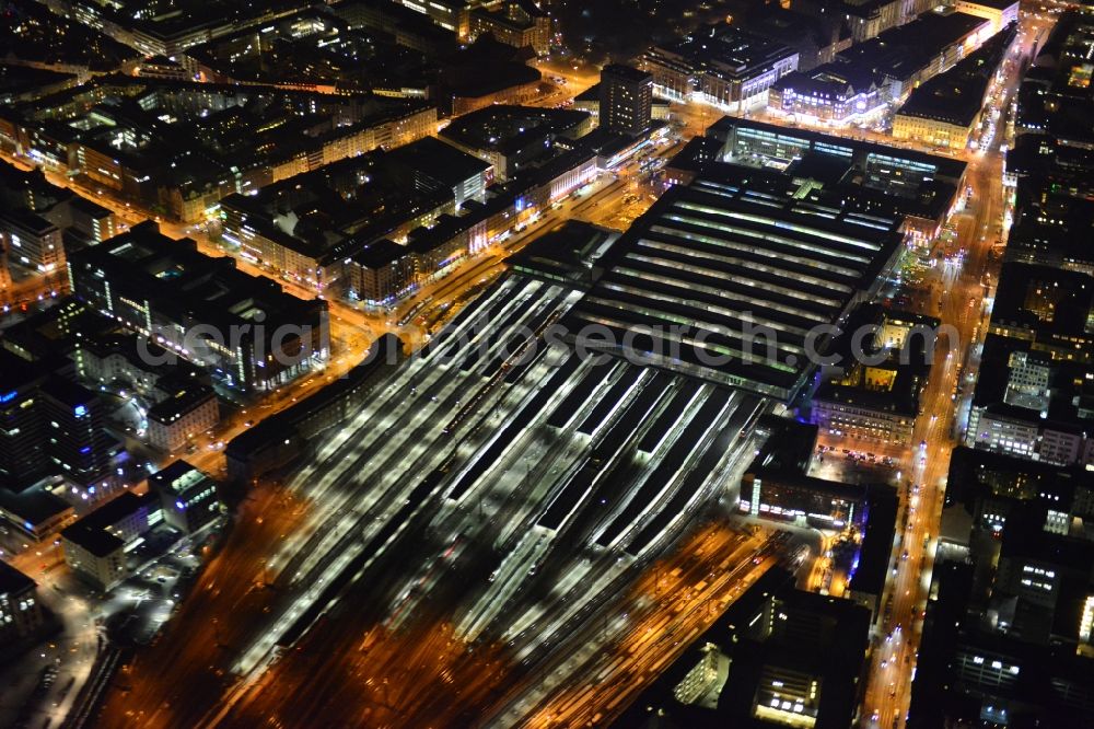 Aerial photograph at night München - Night aerial view of the tracks and rails at the train station building of the main station of Munich in Bavaria