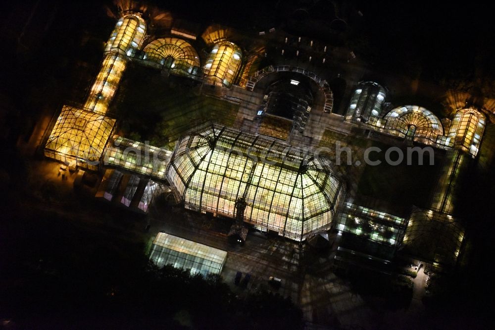 Aerial photograph at night Berlin - Main building and greenhouse complex of the Botanical Gardens Berlin-Dahlem in Berlin. The historical glass buildings and greenhouses are dedicated to different areas. The Large Tropical House and the Victoria-House are located in the center