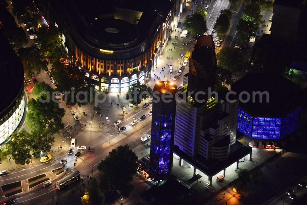 Berlin at night from above - Night aerial view of the Kaiser Wilhelm Memorial Church and commercial space on the Kurfürstendamm in Berlin- Charlottenburg. The ruin at Breitscheidplatz now serves as a museum and memorial. At this time it the Church it is covered up for renovation work. In the office and retail space on Kurfürstendamm 237 reside branches of Commerzbank and Barmer GEK among others