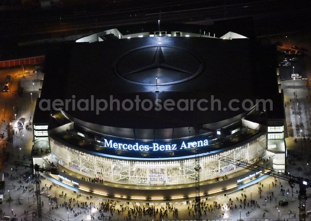 Berlin at night from above - Night view of Mercedes-Benz-Arena on the Spree riverbank in the Friedrichshain part of Berlin. The former O2 World - now Mercedes-Benz-Arena - is located in the Anschutz Areal, a business and office space on the riverbank