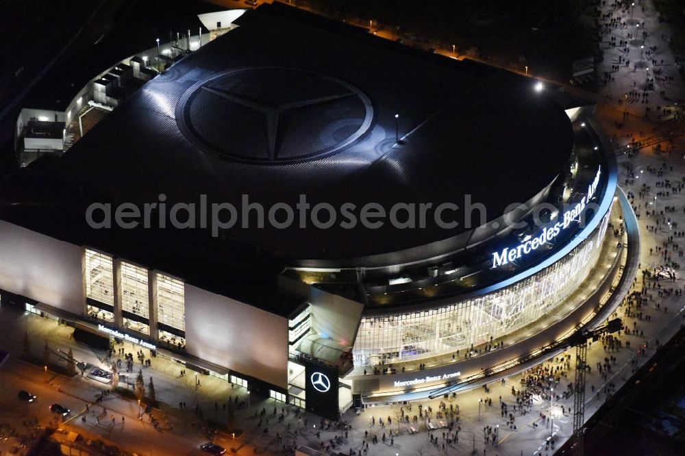 Berlin at night from above - Night view of Mercedes-Benz-Arena on the Spree riverbank in the Friedrichshain part of Berlin. The former O2 World - now Mercedes-Benz-Arena - is located in the Anschutz Areal, a business and office space on the riverbank