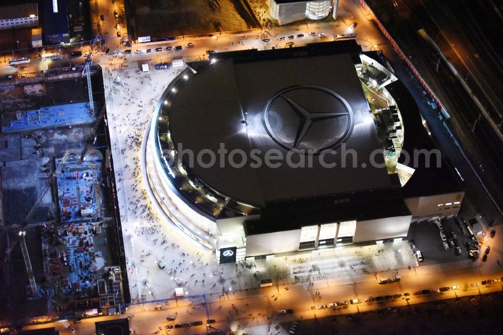 Berlin at night from above - Night view of Mercedes-Benz-Arena on the Spree riverbank in the Friedrichshain part of Berlin. The former O2 World - now Mercedes-Benz-Arena - is located in the Anschutz Areal, a business and office space on the riverbank