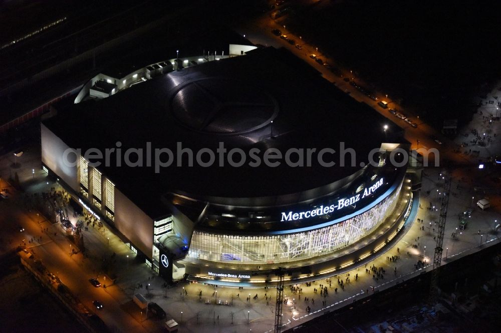 Berlin at night from above - Night view of Mercedes-Benz-Arena on the Spree riverbank in the Friedrichshain part of Berlin. The former O2 World - now Mercedes-Benz-Arena - is located in the Anschutz Areal, a business and office space on the riverbank