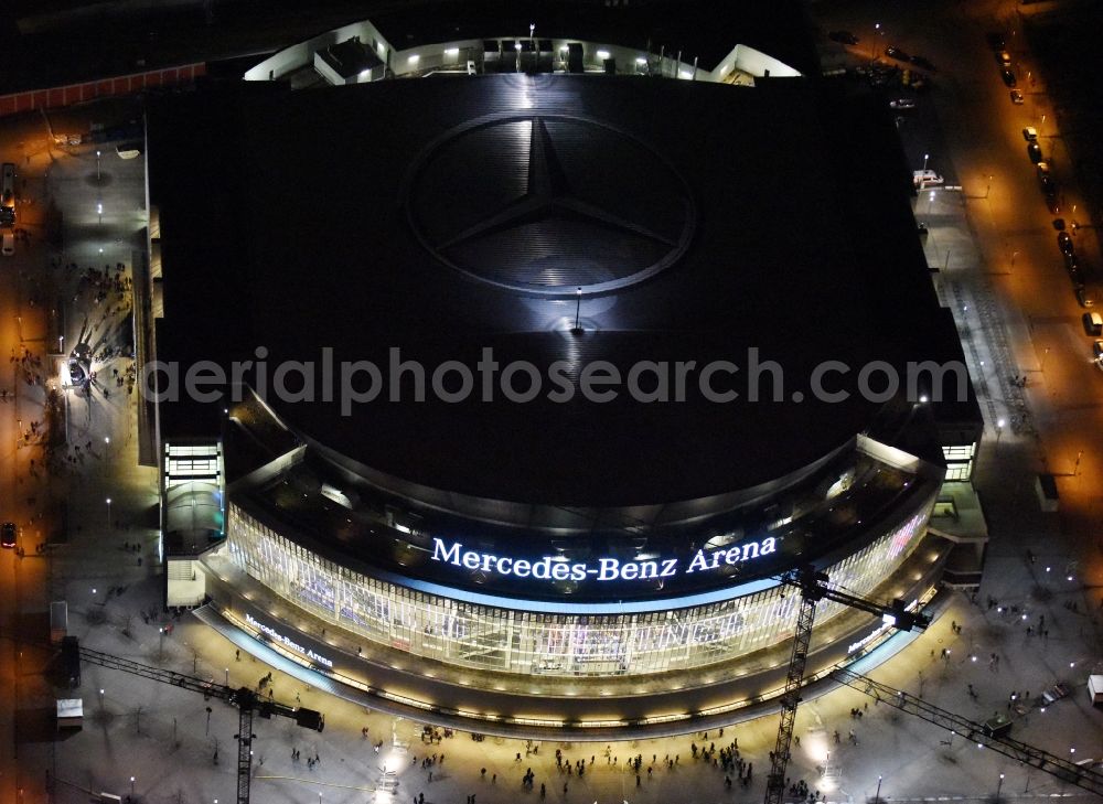 Berlin at night from above - Night view of Mercedes-Benz-Arena on the Spree riverbank in the Friedrichshain part of Berlin. The former O2 World - now Mercedes-Benz-Arena - is located in the Anschutz Areal, a business and office space on the riverbank