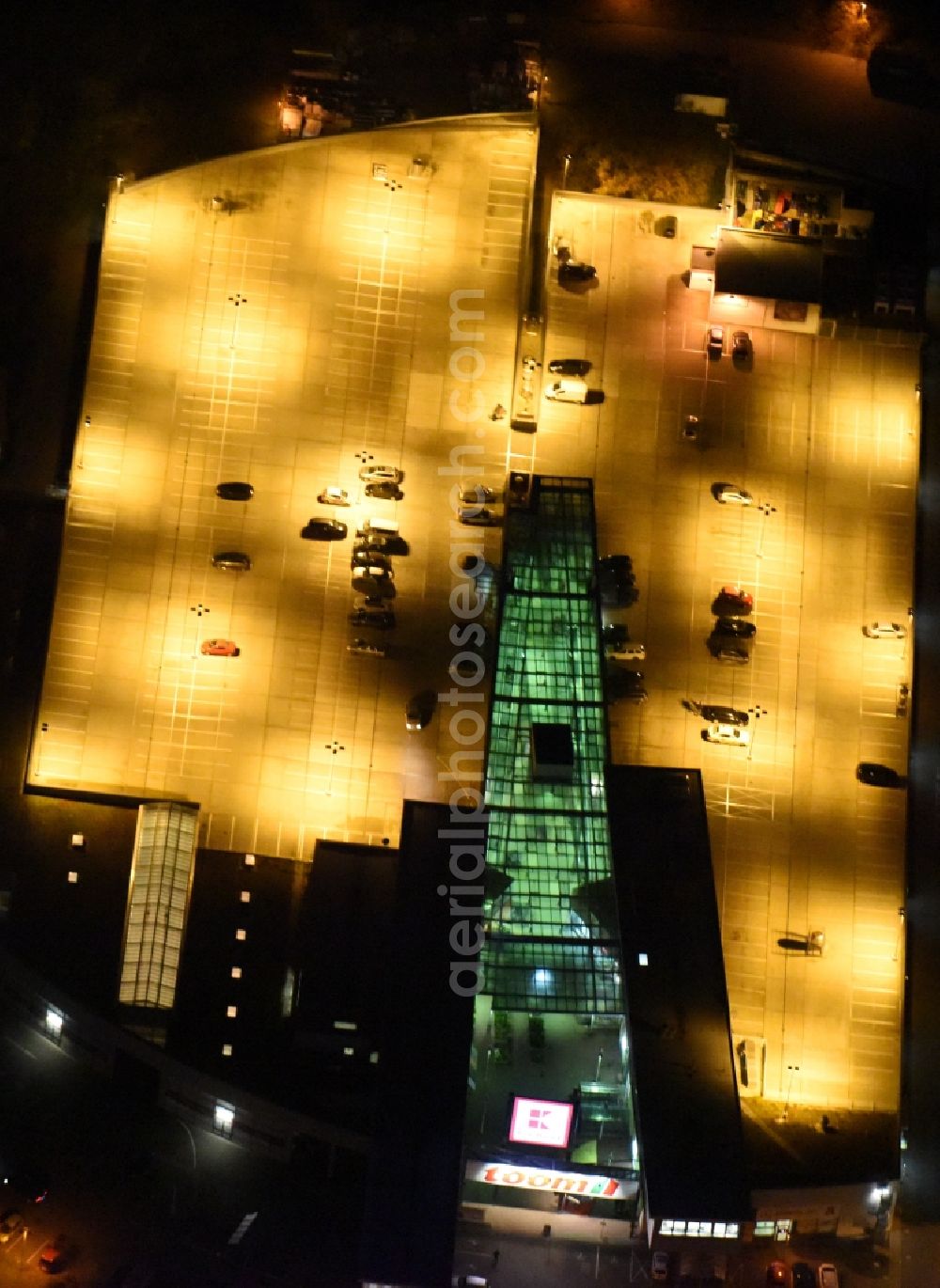 Berlin at night from above - Night aerial view on an automobile and automotive parking- area of a shopping mall in the Koepenick district of Berlin