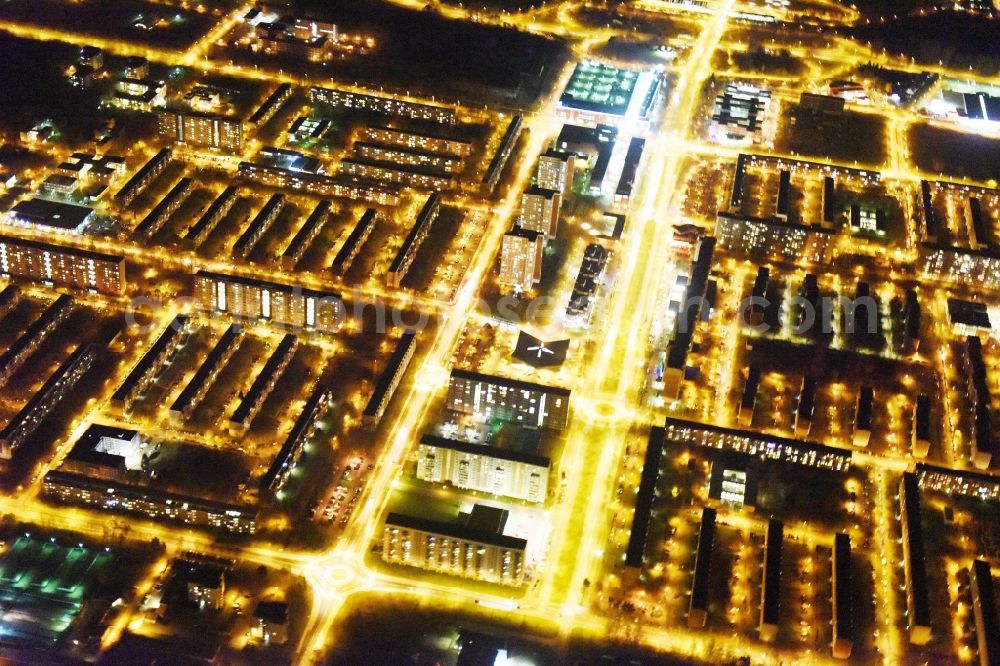 Rostock at night from the bird perspective: Night view skyscrapers in the residential area of industrially manufactured settlement Luetten Klein aloung the Warnowallee in Rostock in the state Mecklenburg - Western Pomerania