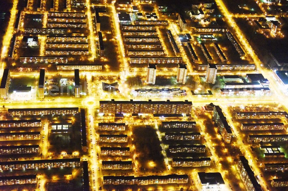 Rostock at night from the bird perspective: Night view skyscrapers in the residential area of industrially manufactured settlement Luetten Klein aloung the Warnowallee in Rostock in the state Mecklenburg - Western Pomerania