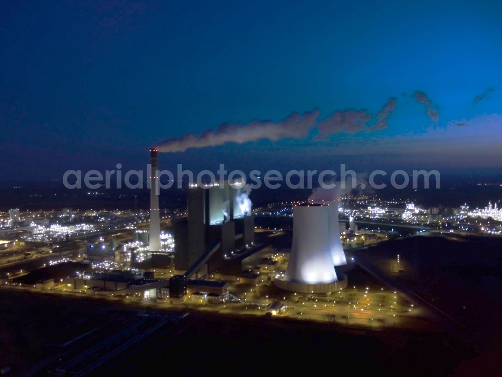 Schkopau at night from the bird perspective: Night view of power plant smokestacks in the mirror image of Rattmansdorfer pond in Schkopau in the state of Saxony-Anhalt. The two chimneys are part of the lignite-fired power plant of E.ON AG