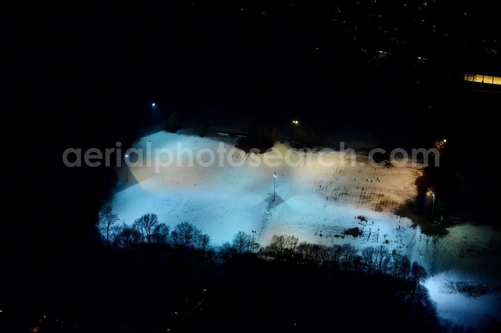 Aerial photograph at night München - Night aerial of the illuminated and snow covered sports ground Ramersdorf in Munich in Bavaria