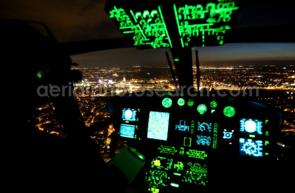 Leipzig at night from the bird perspective: Night aerial view of the skyline of the city center of Leipzig in Saxony from the cockpit of a helicopter squadron of the Federal Police