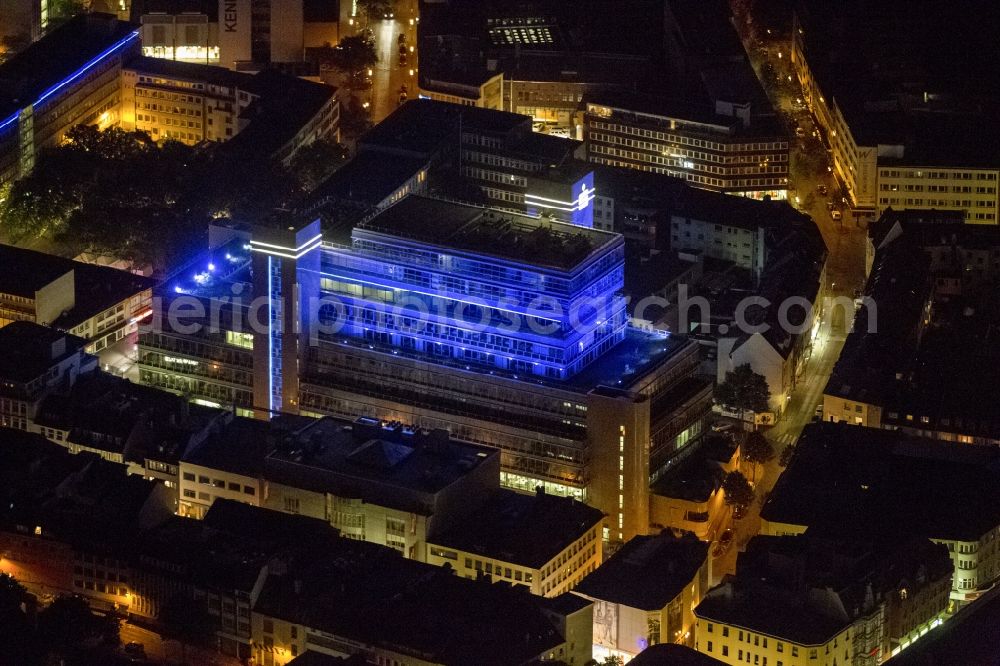 Essen at night from above - Night aerial view of the illuminated blue office building in the Sparkasse Essen in North Rhine-Westphalia. Their business area is the city of Essen.