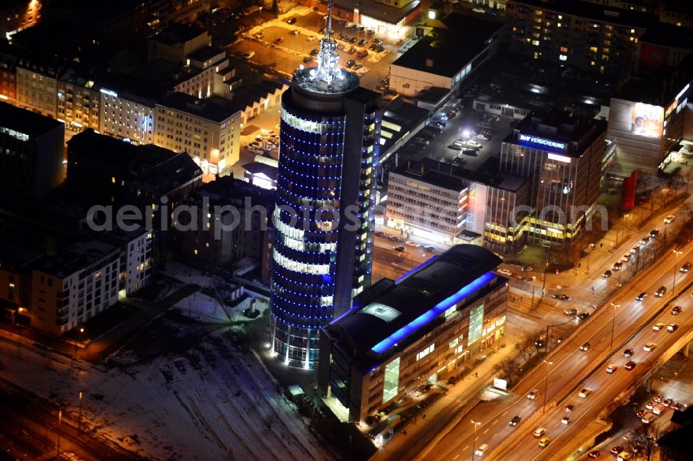 München at night from the bird perspective: Night aerial view of the blue illuminated skyscraper Central Tower in Munich in Bavaria