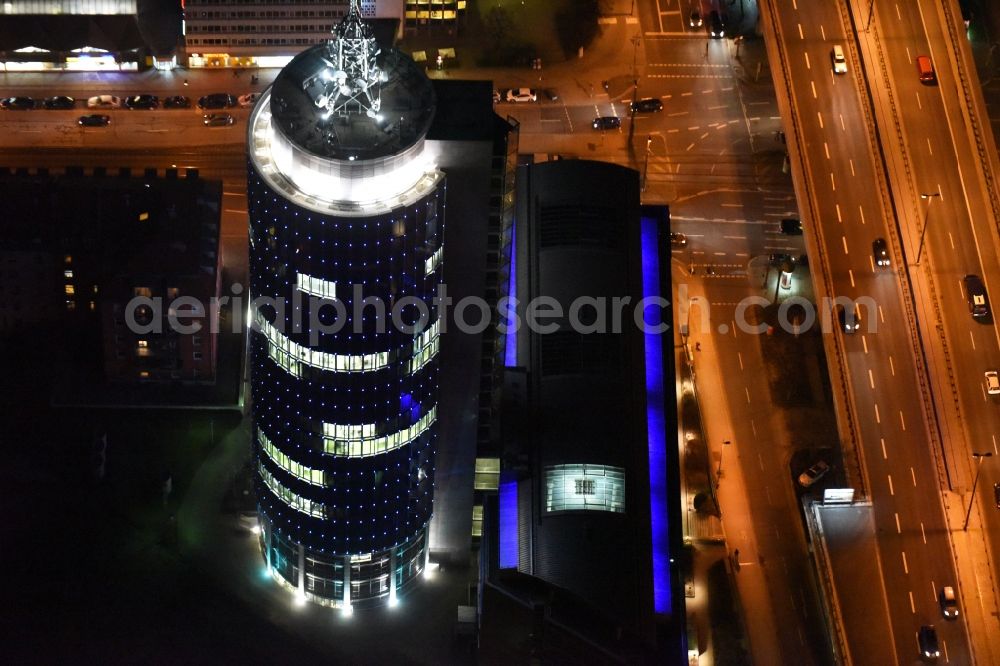 München at night from above - Night aerial view of the blue illuminated skyscraper Central Tower in Munich in Bavaria