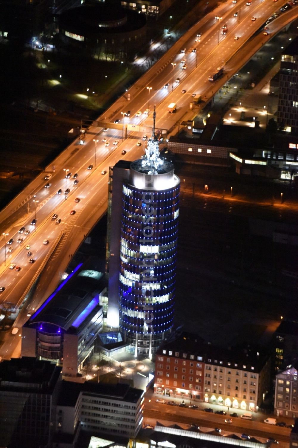 Aerial photograph at night München - Night aerial view of the blue illuminated skyscraper Central Tower in Munich in Bavaria