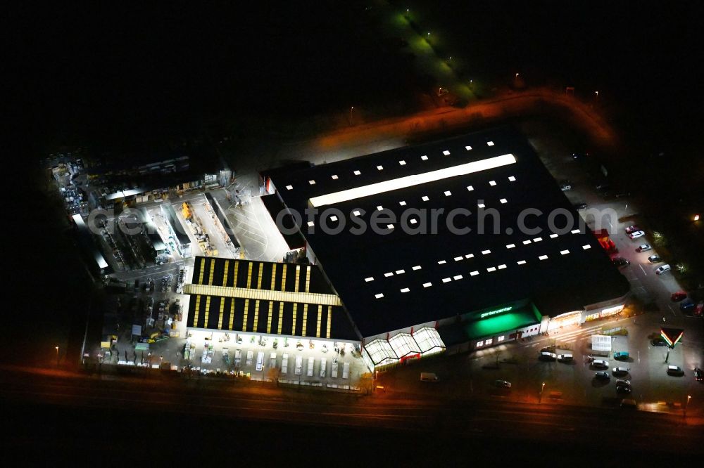 Aerial image at night Wittstock/Dosse - Night lighting Building of the construction market of hagebaumarkt wittstock GmbH + Co. KG on Uetersener Strasse in Wittstock/Dosse in the state Brandenburg, Germany