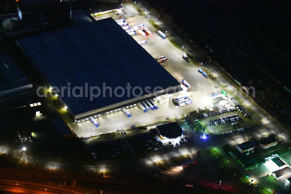 Wittstock/Dosse at night from above - Night lighting Building complex and grounds of the logistics center of ALDI GmbH & Co. Kommandit- gesellschaft on Jabeler Chaussee in Wittstock/Dosse in the state Brandenburg, Germany