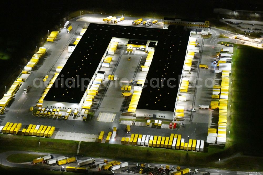 Aerial photograph at night Nohra - Night lighting Building complex and grounds of the logistics center of DHL Paket GmbH on Stangenallee in Nohra in the state Thuringia, Germany