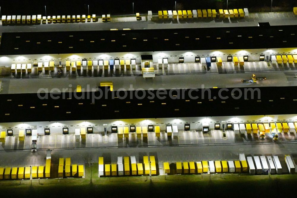 Aerial image at night Nohra - Night lighting Building complex and grounds of the logistics center of DHL Paket GmbH on Stangenallee in Nohra in the state Thuringia, Germany