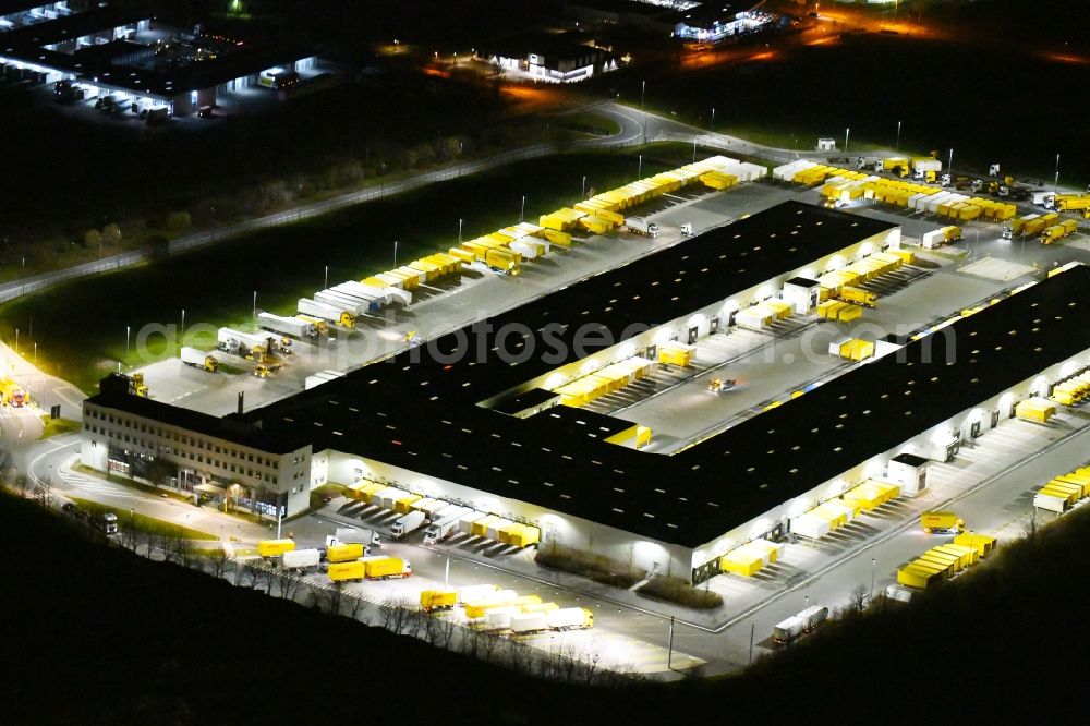 Nohra at night from above - Night lighting Building complex and grounds of the logistics center of DHL Paket GmbH on Stangenallee in Nohra in the state Thuringia, Germany