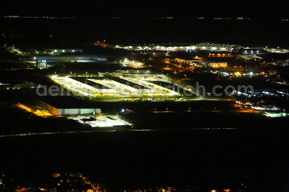 Nohra at night from above - Night lighting Building complex and grounds of the logistics center of DHL Paket GmbH on Stangenallee in Nohra in the state Thuringia, Germany