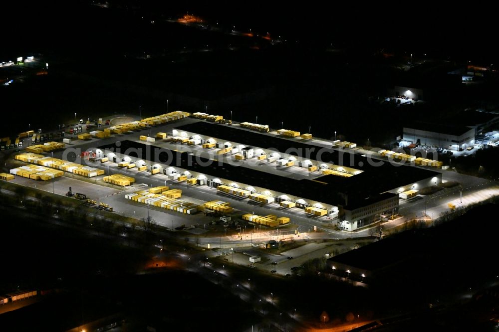 Aerial image at night Nohra - Night lighting Building complex and grounds of the logistics center of DHL Paket GmbH on Stangenallee in Nohra in the state Thuringia, Germany