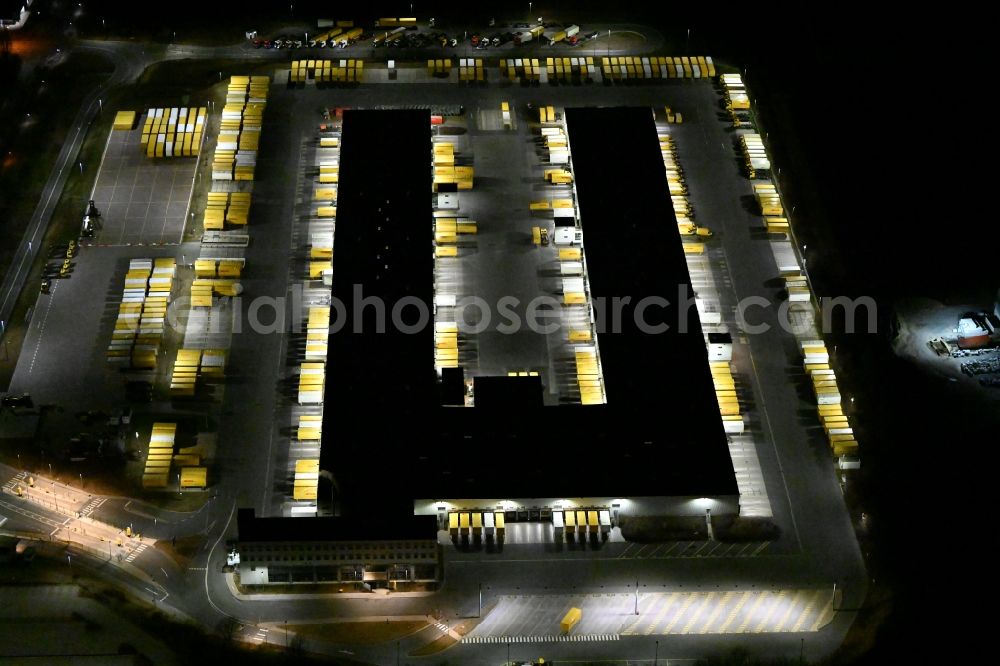 Aerial photograph at night Nohra - Night lighting Building complex and grounds of the logistics center of DHL Paket GmbH on Stangenallee in Nohra in the state Thuringia, Germany