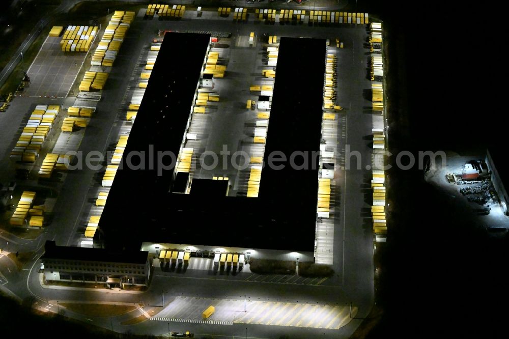 Aerial image at night Nohra - Night lighting Building complex and grounds of the logistics center of DHL Paket GmbH on Stangenallee in Nohra in the state Thuringia, Germany