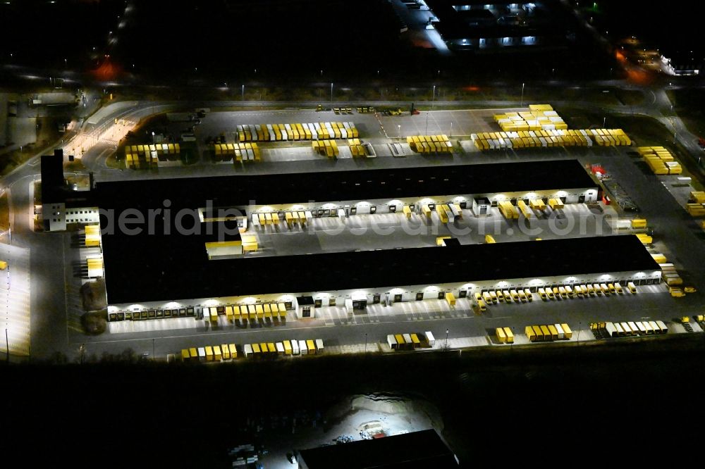 Aerial photograph at night Nohra - Night lighting Building complex and grounds of the logistics center of DHL Paket GmbH on Stangenallee in Nohra in the state Thuringia, Germany