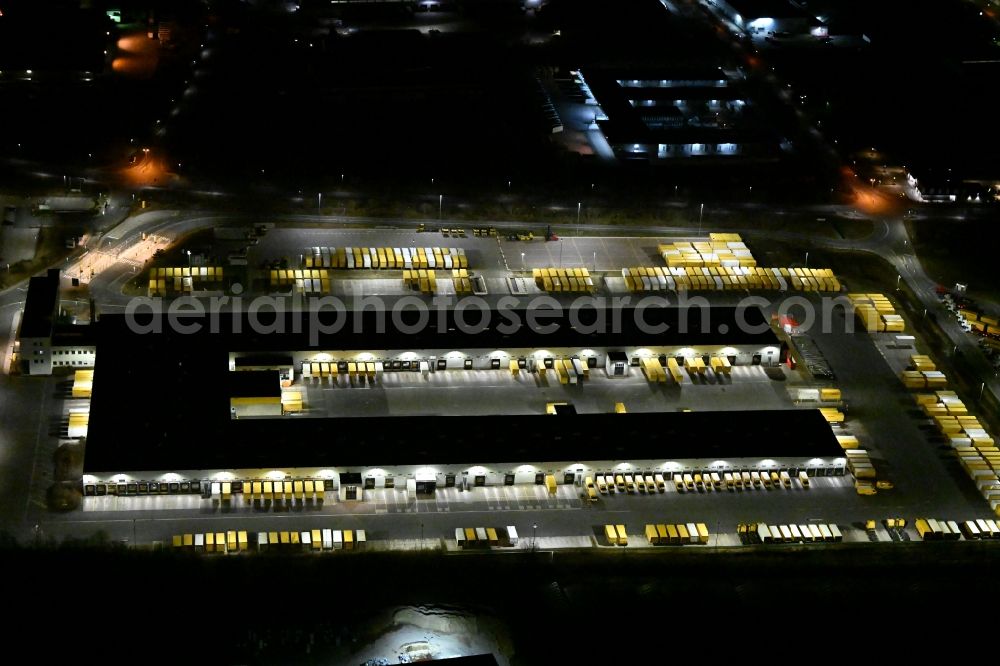 Aerial image at night Nohra - Night lighting Building complex and grounds of the logistics center of DHL Paket GmbH on Stangenallee in Nohra in the state Thuringia, Germany