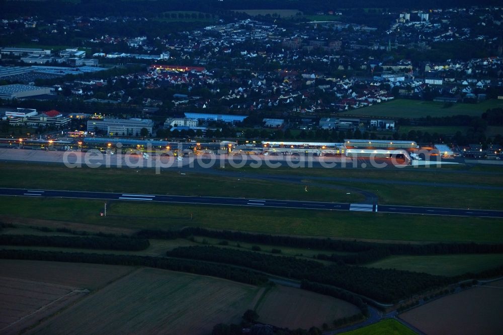 Holzwickede at night from above - Night view of the Runway with hangar taxiways and terminals on the grounds of the airport Flughafen Dortmund Airport 21 (EDLW, DTM) in Holzwickede in the state North Rhine-Westphalia