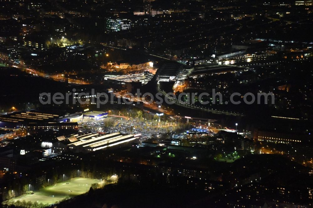 Berlin at night from above - Night image of the industrial estate and company settlement on Bessemerstrasse and Alboinstrasse in Berlin in Germany. The commercial area in the North of Alboinplatz square includes supermarkets, grocery stores, furniture stores and office buildings located in old factories