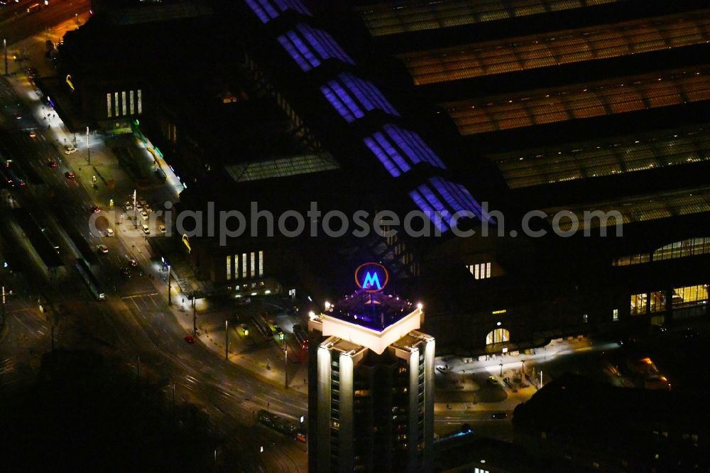 Aerial image at night Leipzig - Night lighting the fair logotype neon sign on the roof of the High-Rise building complex of the headquarters of the Leipziger Wohnungs- und Baugesellschaft (LWB) on Wintergartenhochhaus - skyscraper in Leipzig in Saxony