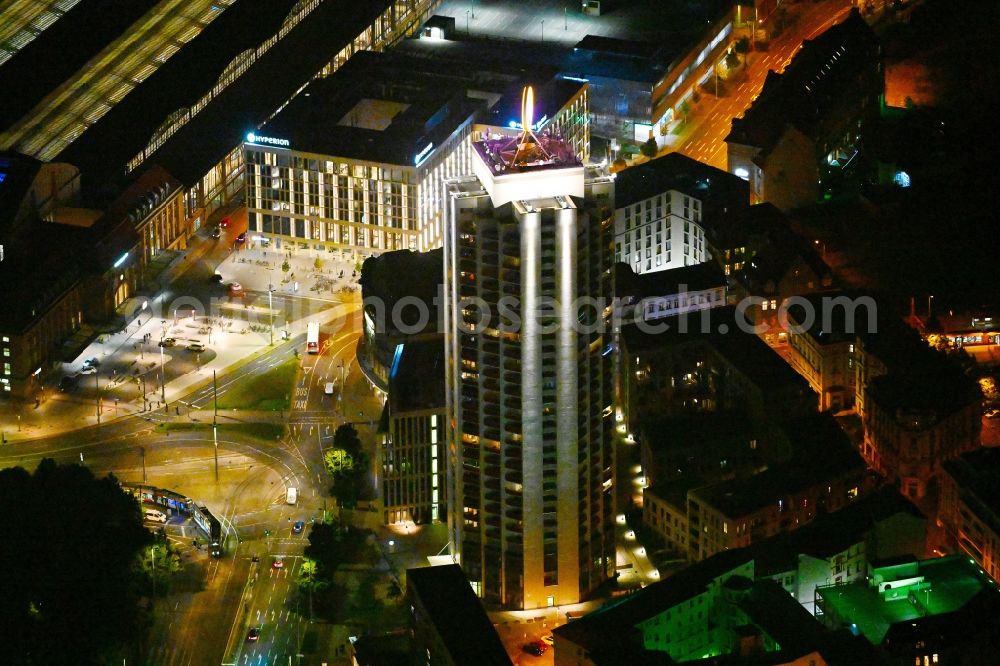 Aerial image at night Leipzig - Night lighting the fair logotype neon sign on the roof of the High-Rise building complex of the headquarters of the Leipziger Wohnungs- und Baugesellschaft (LWB) on Wintergartenhochhaus - skyscraper in Leipzig in Saxony