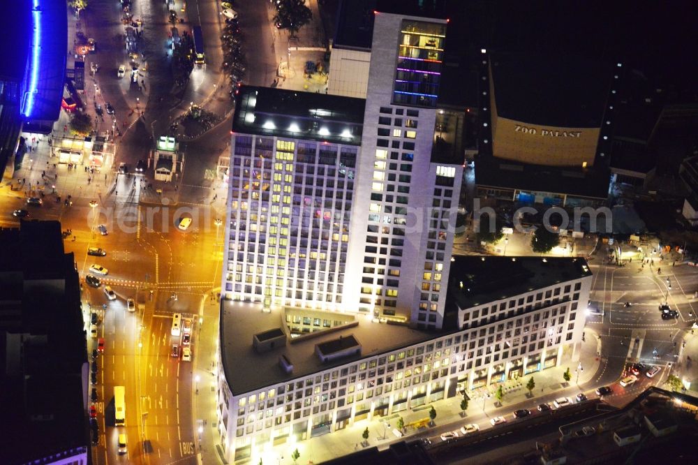 Berlin at night from the bird perspective: Illuminated building of the skyscraper Zoofenster during the annual Festival of Lights event in Berlin Charlottenburg. The Zoofenster in Hardenbergstrasse is the location of office and retail space as well as the first Waldorf Astoria Hotel in Germany. Also visible is the renovation and expansion construction at the traditional Zoo Palast cinema, which is part of the bikini-house construction project. Developer, project manager and investor for the project Bikini Berlin is the Bayrische Hausbau GmbH & Co. KG